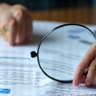 Image representing tenant screening with documents and magnifiying glass